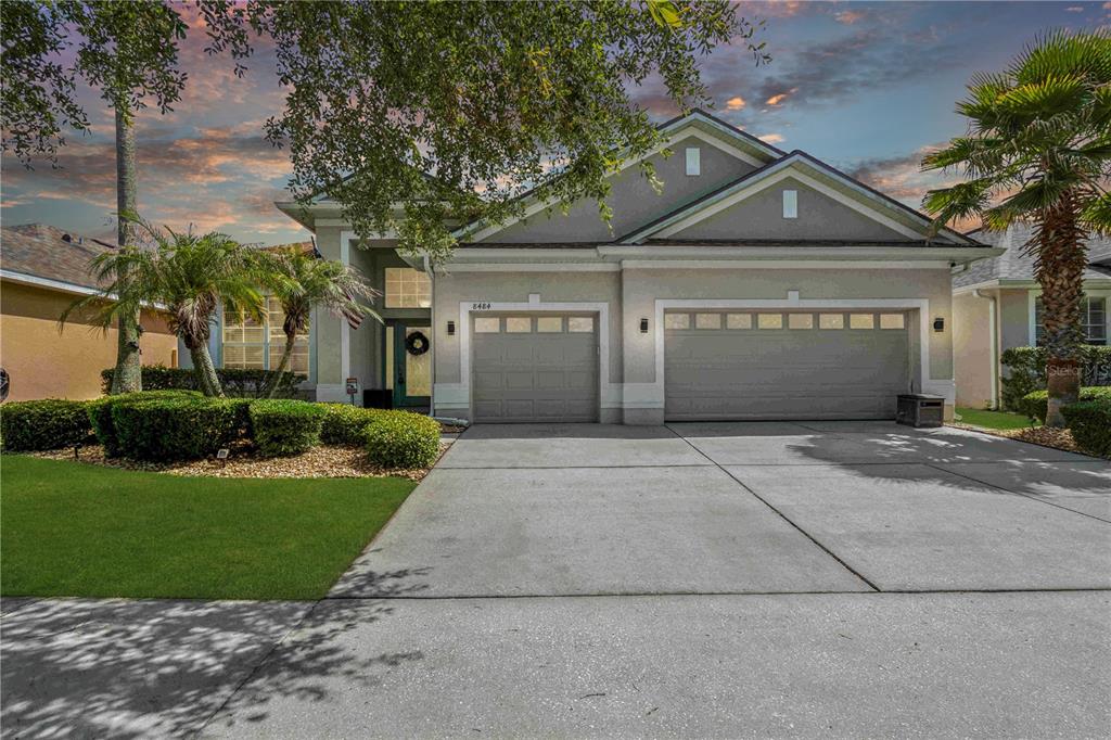 8484 Dover View Lane Orlando, FL 32829 - Photo 1 of 41 a front view of a house with a yard and garage