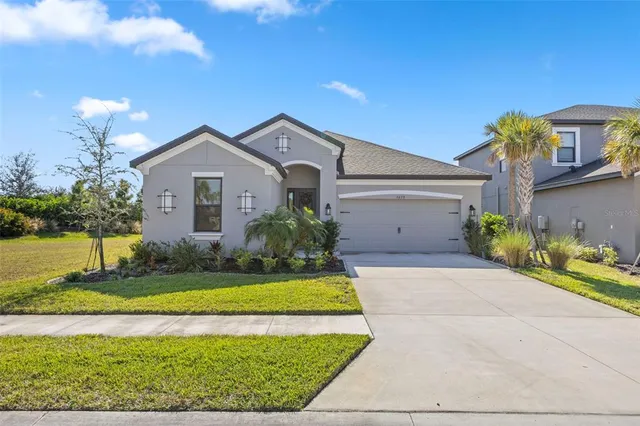 a front view of a house with a yard and garage