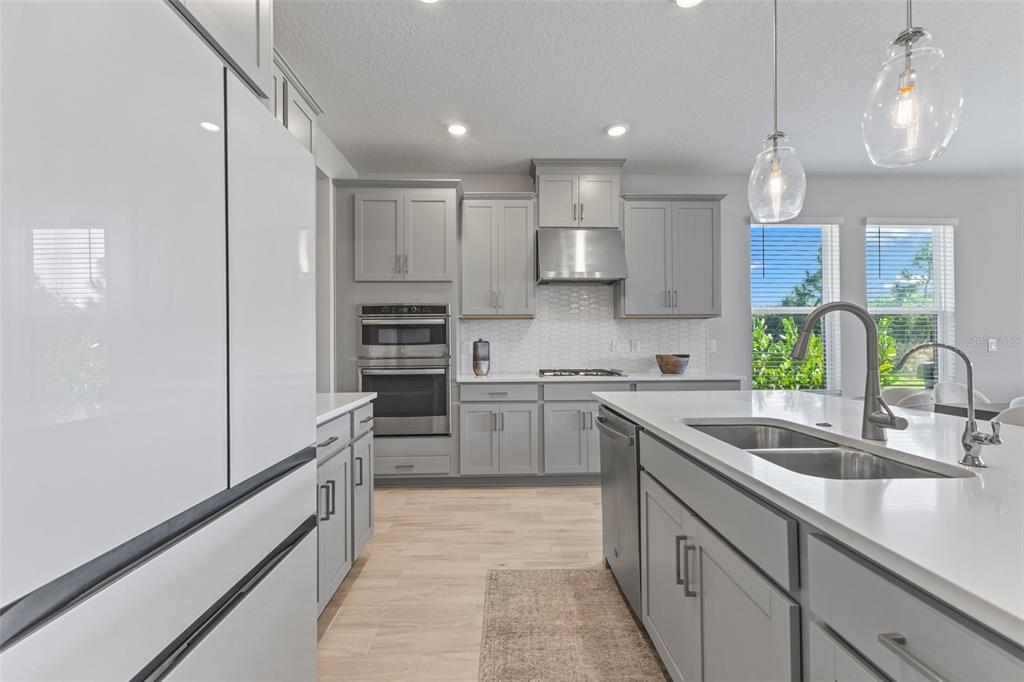 5679 Blue Reef Place Nokomis, FL 34275 - Photo 13 of 46 a kitchen with kitchen island granite countertop a sink counter top space stainless steel appliances and cabinets