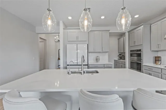 a bathroom with a sink a toilet and a large mirror