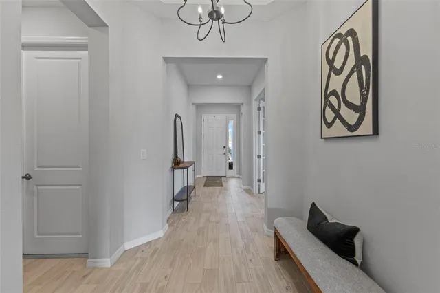 a view of a hallway with wooden floor and closet