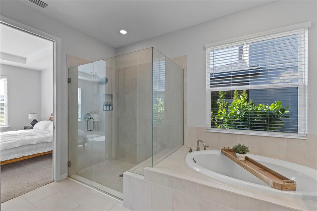 5679 Blue Reef Place Nokomis, FL 34275 - Photo 21 of 46 a bathroom with a tub a sink and a large mirror