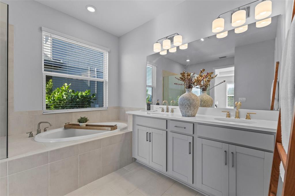 5679 Blue Reef Place Nokomis, FL 34275 - Photo 22 of 46 a bathroom with a sink a large mirror and a window