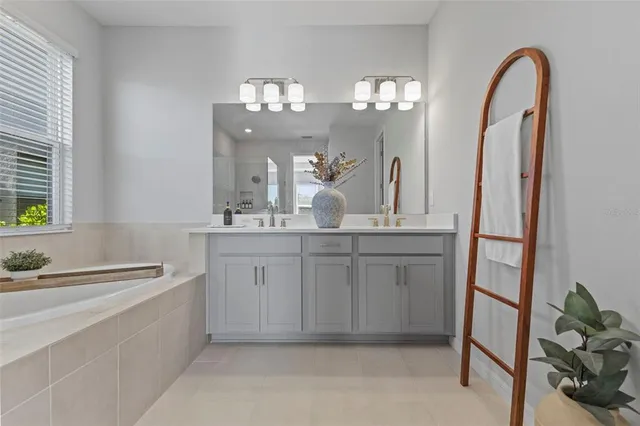 a spacious bathroom with a double vanity sink and a mirror