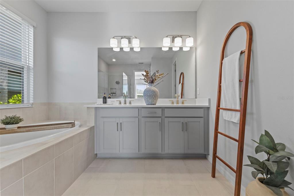 5679 Blue Reef Place Nokomis, FL 34275 - Photo 23 of 46 a spacious bathroom with a double vanity sink and a mirror
