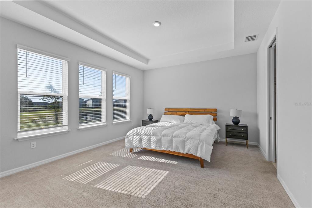 5679 Blue Reef Place Nokomis, FL 34275 - Photo 25 of 46 a bedroom with a bed and a large window