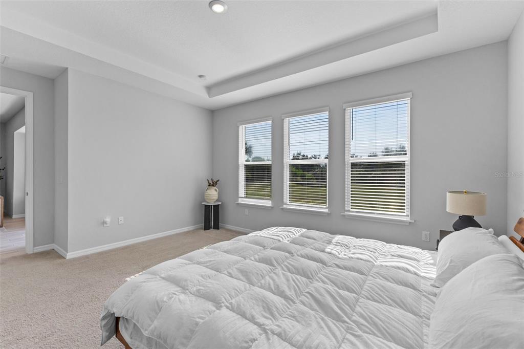 5679 Blue Reef Place Nokomis, FL 34275 - Photo 26 of 46 a bedroom with a bed and a large window