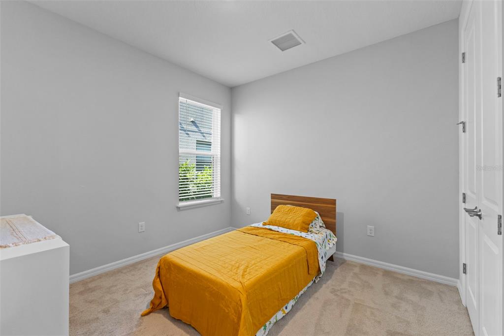 5679 Blue Reef Place Nokomis, FL 34275 - Photo 30 of 46 a bedroom with a bed and window