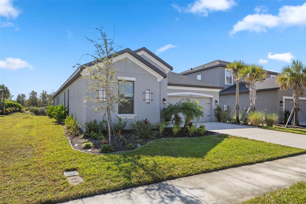 5679 Blue Reef Place Nokomis, FL 34275 - Photo 3 of 46 a front view of a house with garden