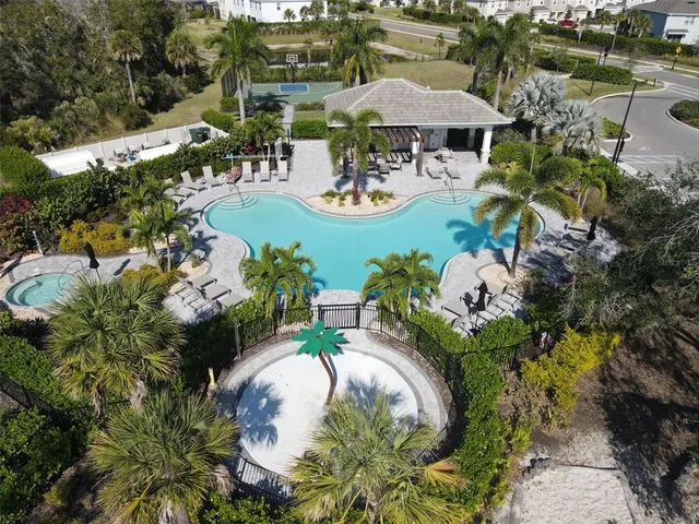 an aerial view of a house with a swimming pool patio and outdoor seating
