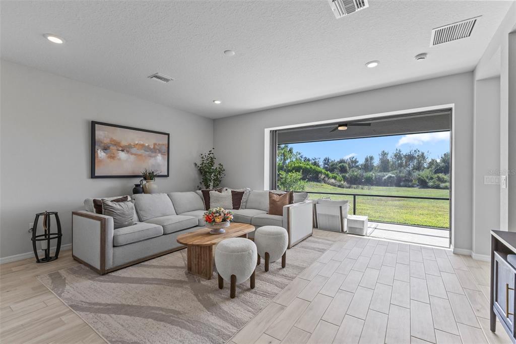 5679 Blue Reef Place Nokomis, FL 34275 - Photo 46 of 46 a living room with furniture and a large window