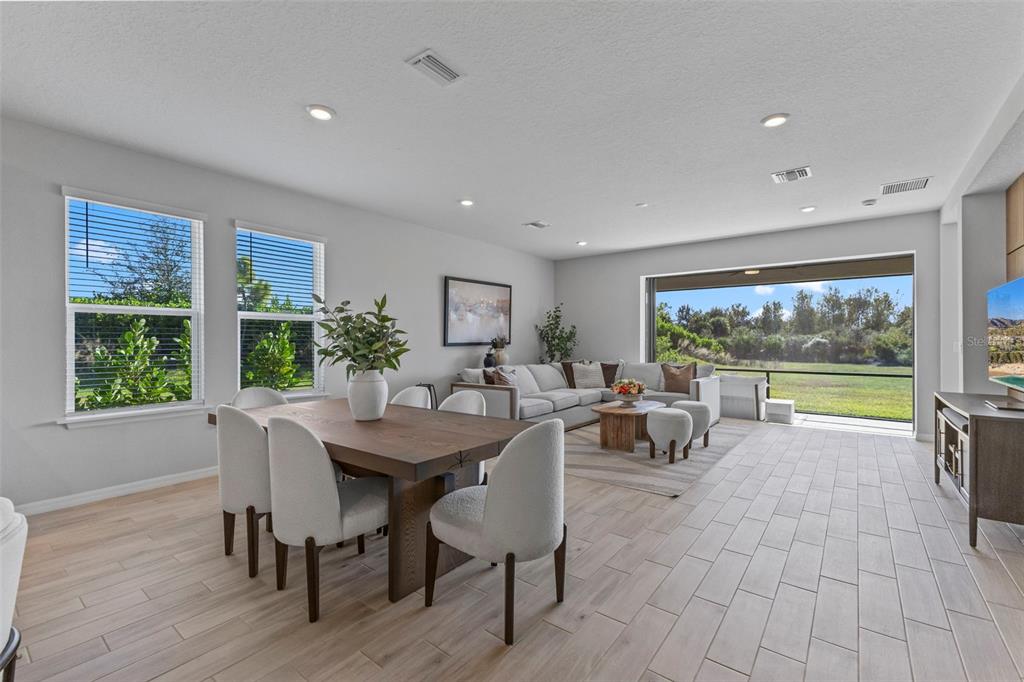 5679 Blue Reef Place Nokomis, FL 34275 - Photo 8 of 46 a living room with furniture and a large window