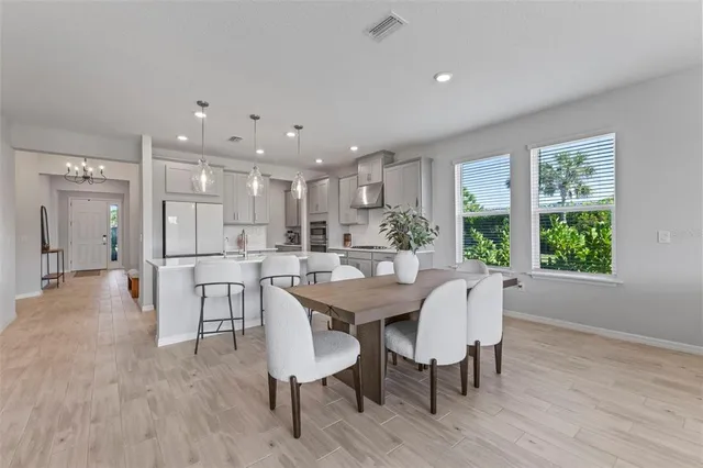 a view of a dining room with furniture and wooden floor