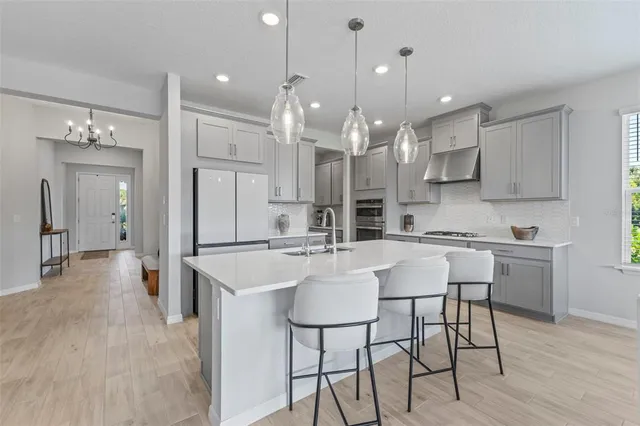 a large kitchen with a table and chairs