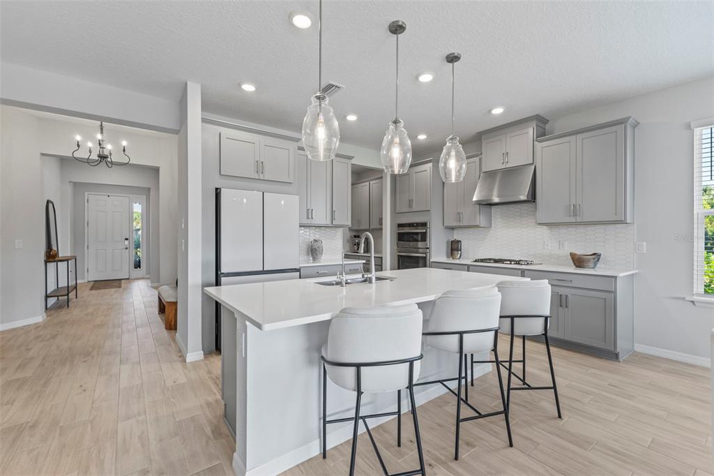 5679 Blue Reef Place Nokomis, FL 34275 - Photo 10 of 46 a large kitchen with a table and chairs