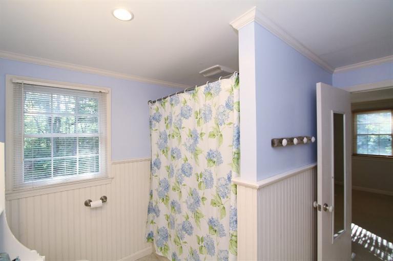 77 Sheffield Road Brewster, MA 02631 - Photo 15 of 26 a bathroom with a shower curtain and a window