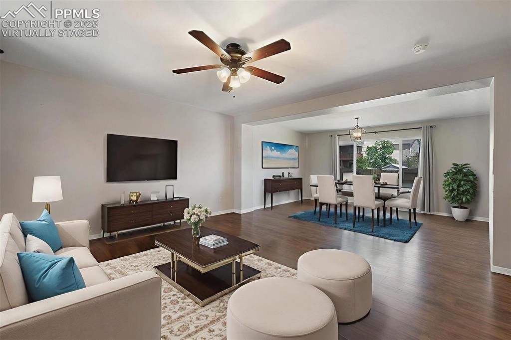12206 Crystal Downs Road Peyton, CO 80831 - Photo 3 of 26 a living room with furniture and a flat screen tv with wooden floor