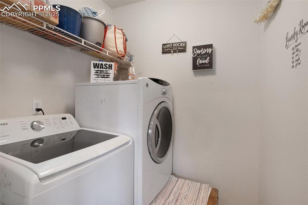 12206 Crystal Downs Road Peyton, CO 80831 - Photo 9 of 26 a utility room with dryer and washer