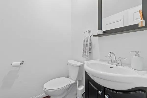 a bathroom with a sink a toilet and mirror