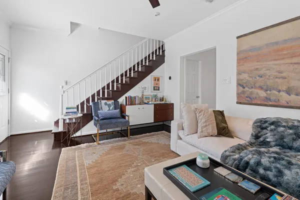 a living room with furniture and wooden floor