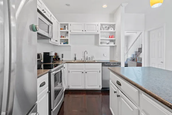 a kitchen with cabinets a sink and appliances