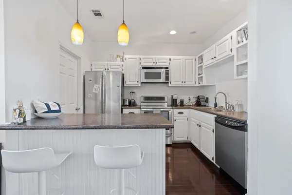 a kitchen with stainless steel appliances granite countertop a sink and a stove