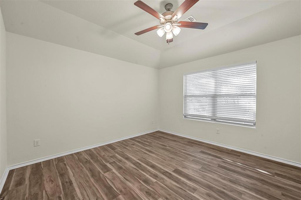 105 Southeast 4th Street, Unit 1 Kerens, TX 75144 - Photo 12 of 23 wooden floor in an empty room with a window