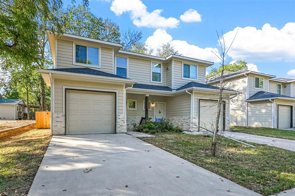 105 Southeast 4th Street, Unit 1 Kerens, TX 75144 - Photo 18 of 23 a front view of a house with a yard and garage