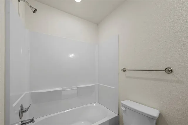 a bathroom with a shower and toilet