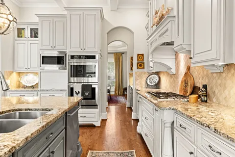 a kitchen with stainless steel appliances granite countertop a stove and a sink