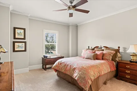 a bed room with a bed and two window