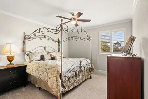 a bedroom with a bed dresser and a window