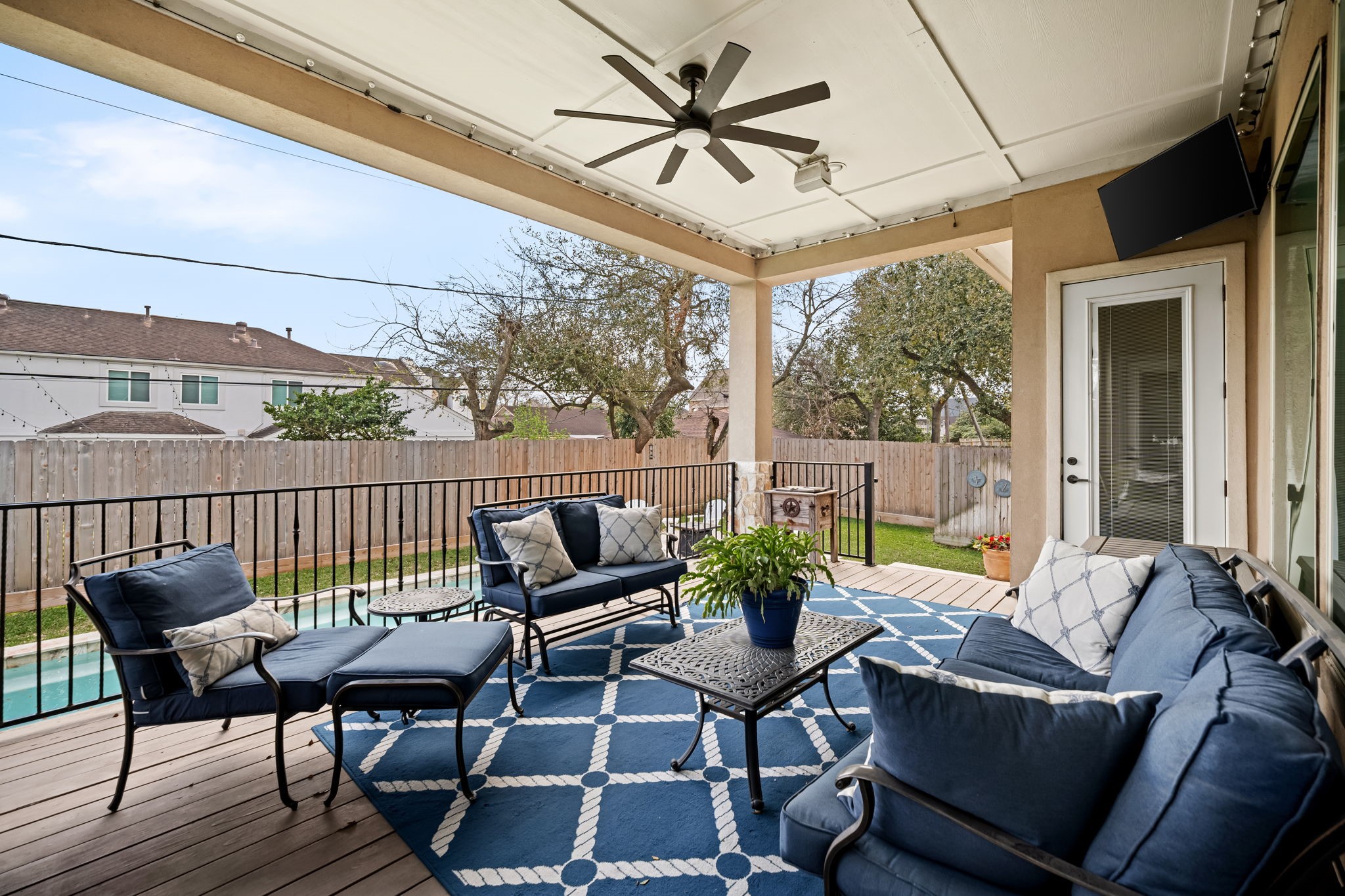 4823 Jason Street Houston, TX 77096 - Photo 34 of 40 This inviting outdoor covered patio features a large space, perfect for relaxing outdoors. It overlooks a fenced backyard with a view of the pool, ideal for relaxation and entertaining.