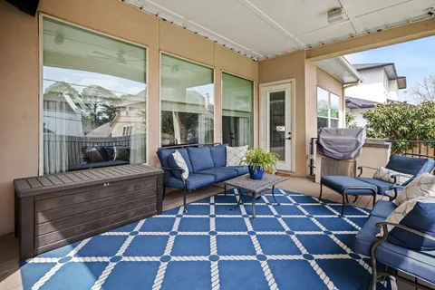a view of a deck with furniture and garden