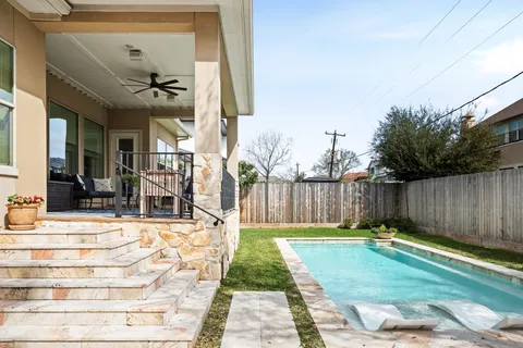a view of a house with pool table and chairs