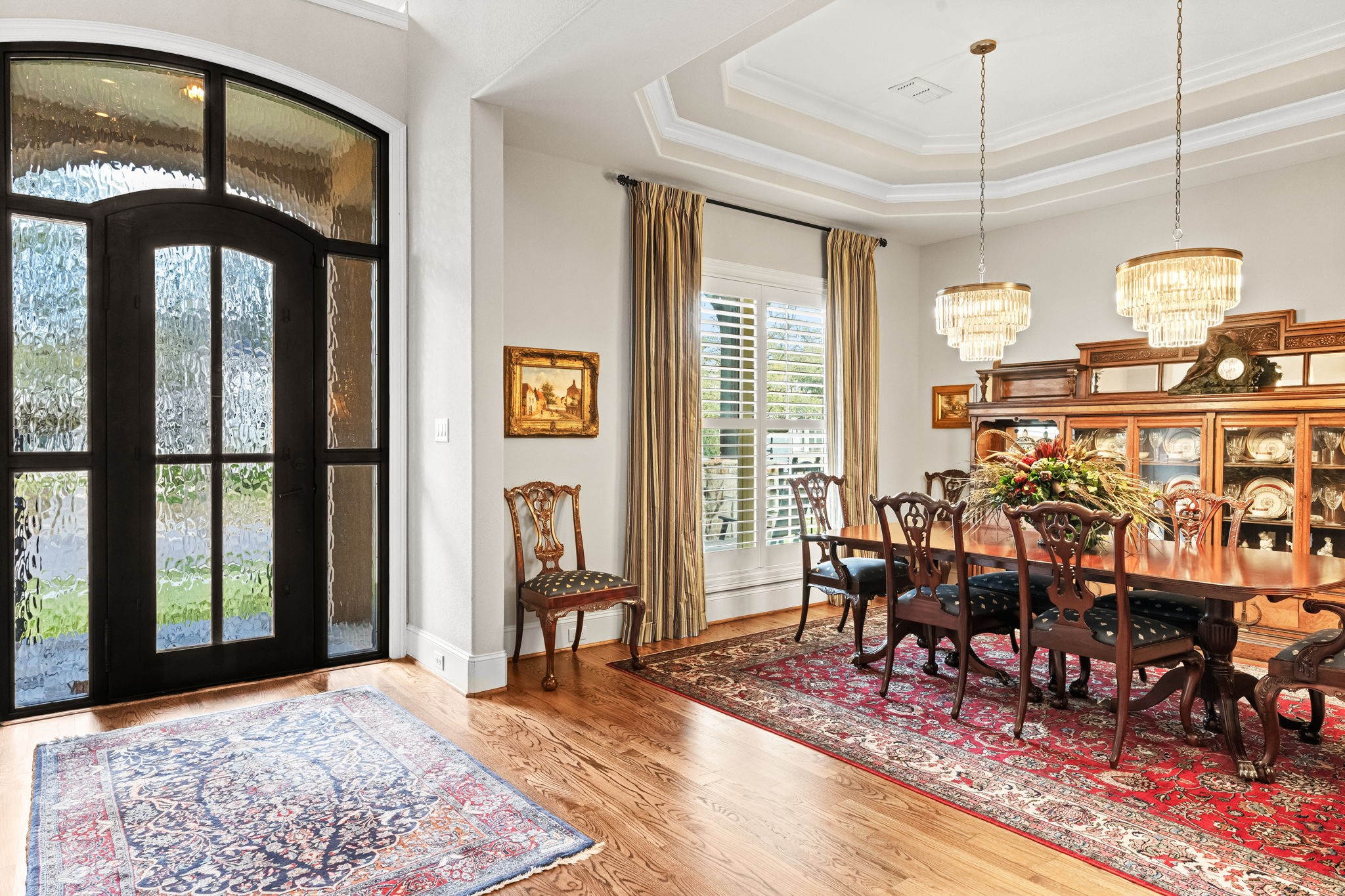 4823 Jason Street Houston, TX 77096 - Photo 7 of 40 This elegant dining area features hardwood floors and is illuminated by two chandeliers and natural light from a window with plantation shutters.