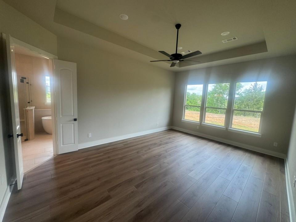 412 Indian Crk Road Van Alstyne, TX 75495 - Photo 13 of 24 wooden floor in an empty room with a window