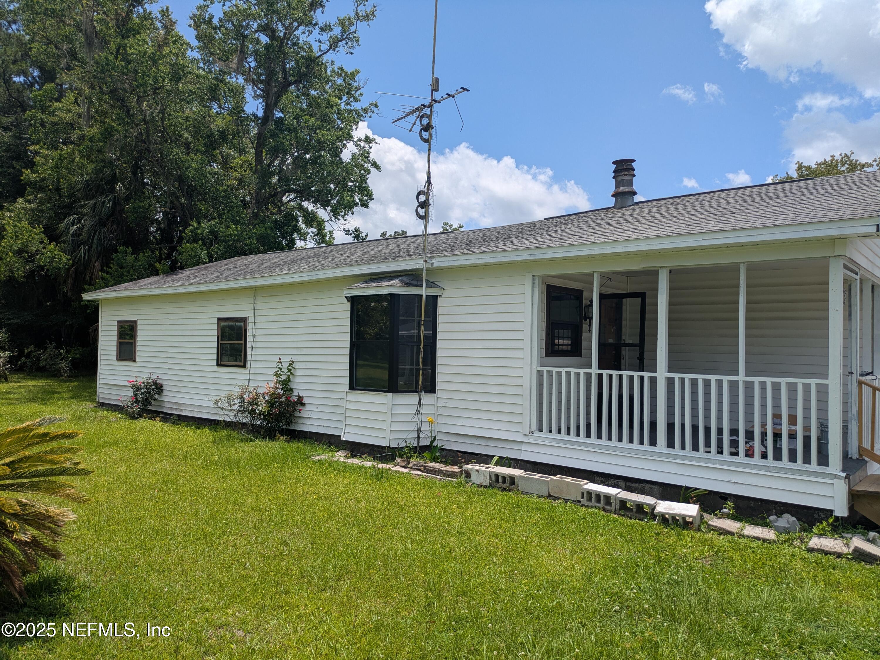54559 Marlee Road Callahan, FL 32011 - Photo 1 of 33 a view of a house with a yard and sitting area