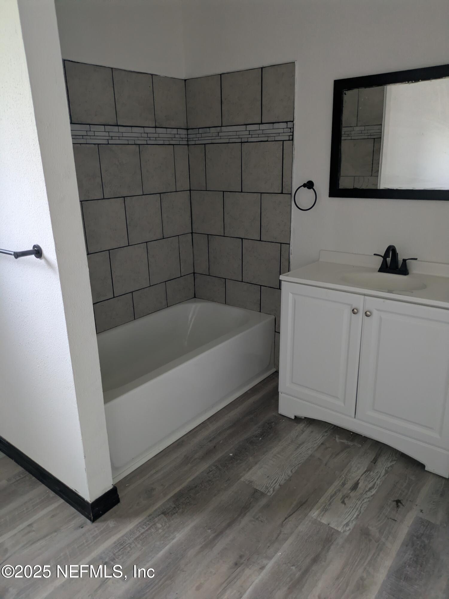 54559 Marlee Road Callahan, FL 32011 - Photo 11 of 33 a bathroom with a bathtub and mirror