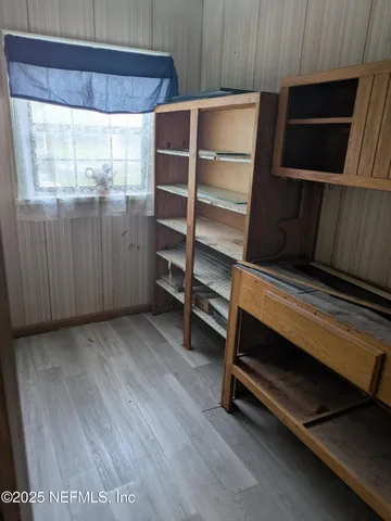 a room with walk in closet and window