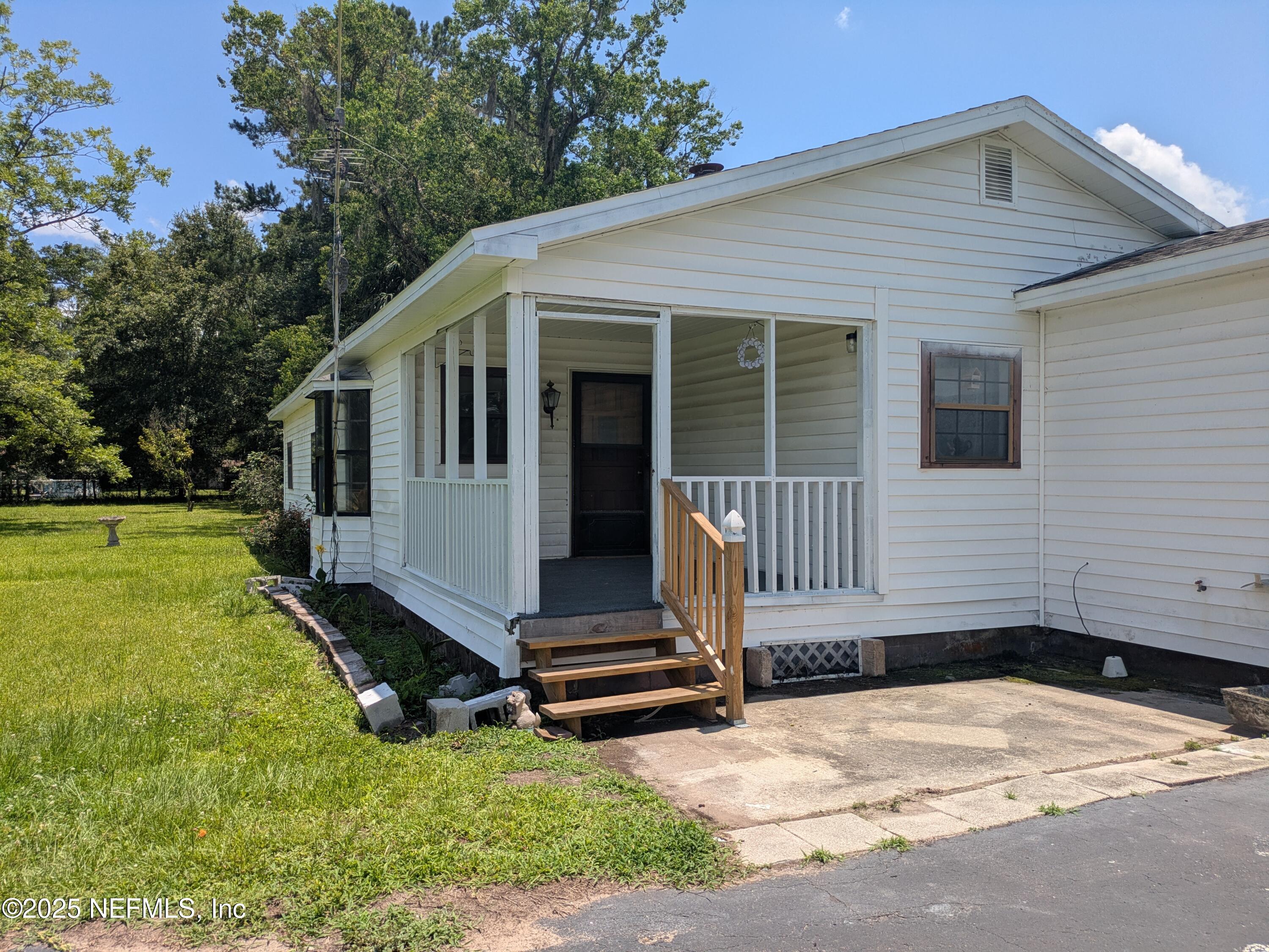 54559 Marlee Road Callahan, FL 32011 - Photo 3 of 33 a front view of a house with a yard