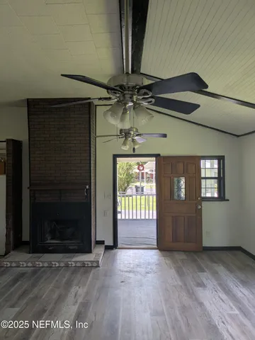 a view of a room with wooden floor