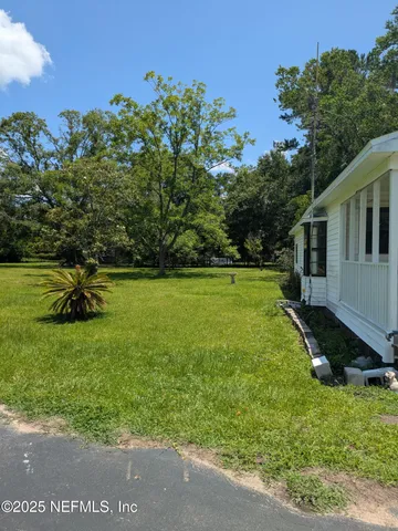 a view of a backyard with plants and a garden