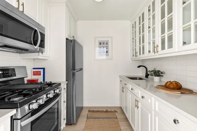 a kitchen with stainless steel appliances granite countertop a stove and a refrigerator