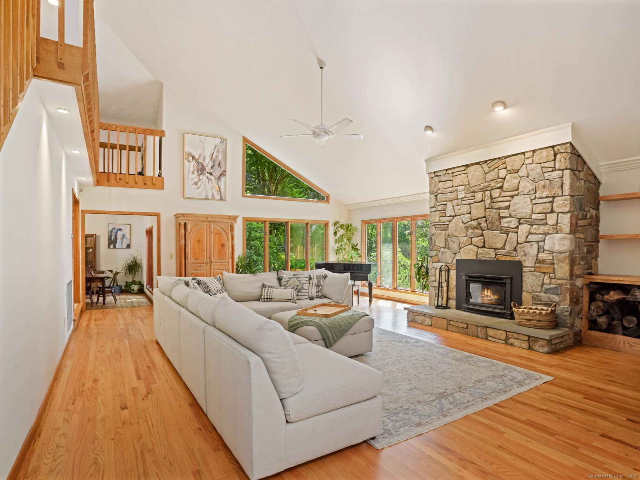 a living room with furniture large window and a fireplace