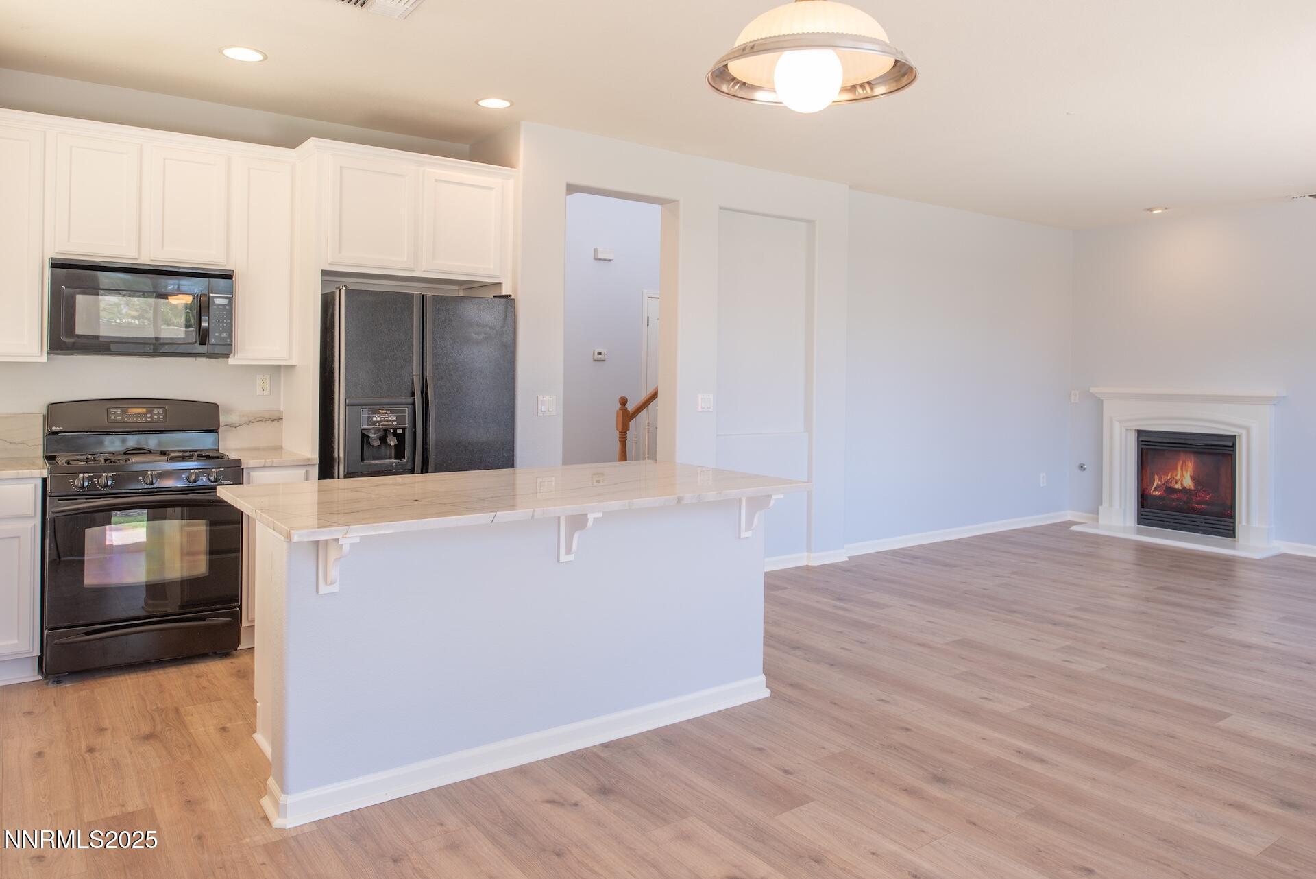 10630 Birch Point Court Reno, NV 89521 - Photo 5 of 42 a kitchen with granite countertop a stove and a refrigerator