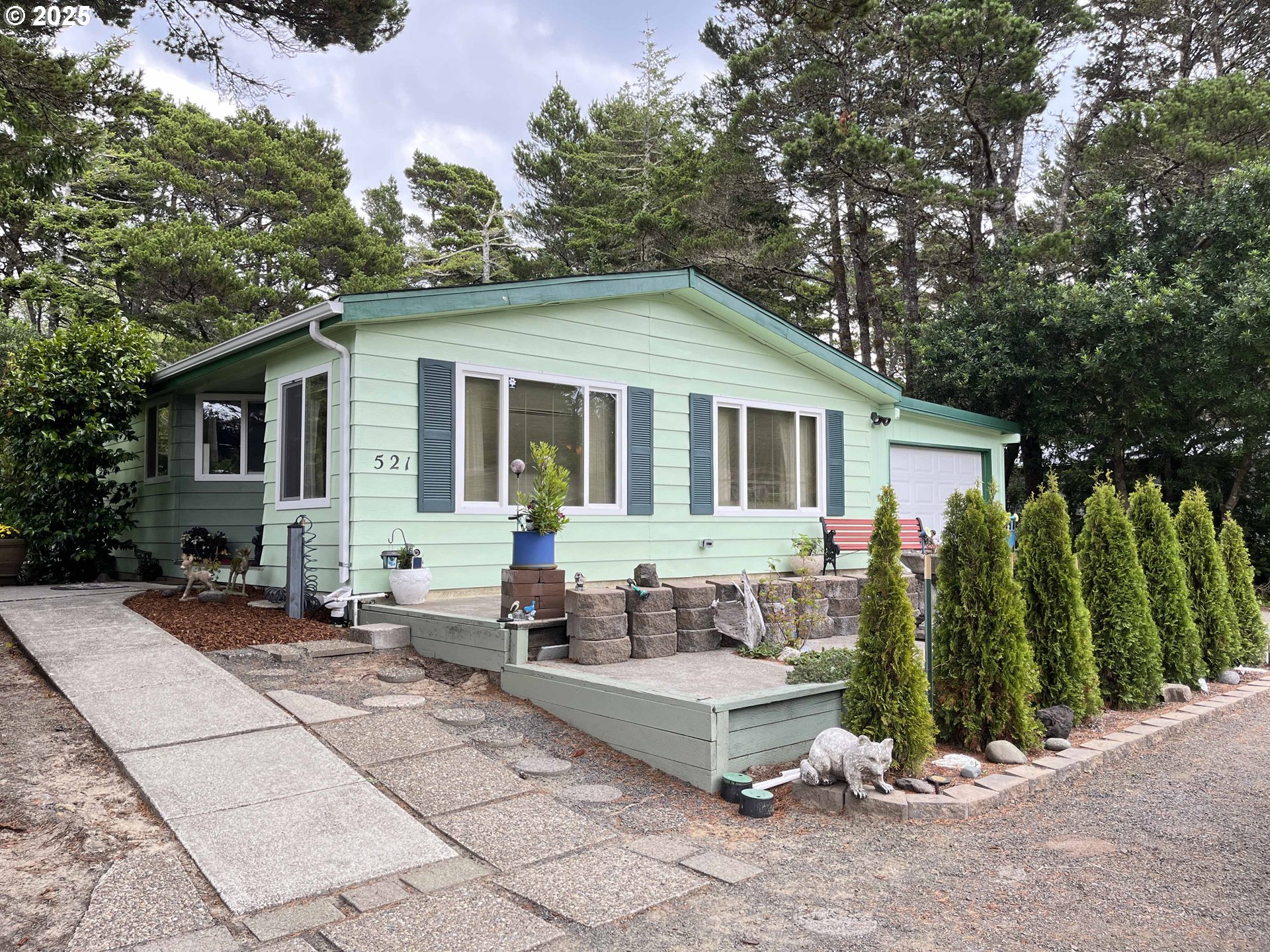 a view of a house with backyard and sitting area