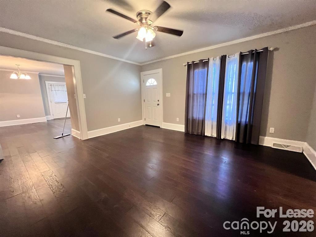 2104 Moose Road Kannapolis, NC 28083 - Photo 9 of 20 a view of a livingroom with wooden floor and a ceiling fan