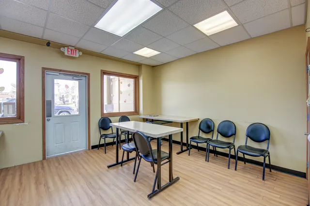 a view of house with yard and trees in the background