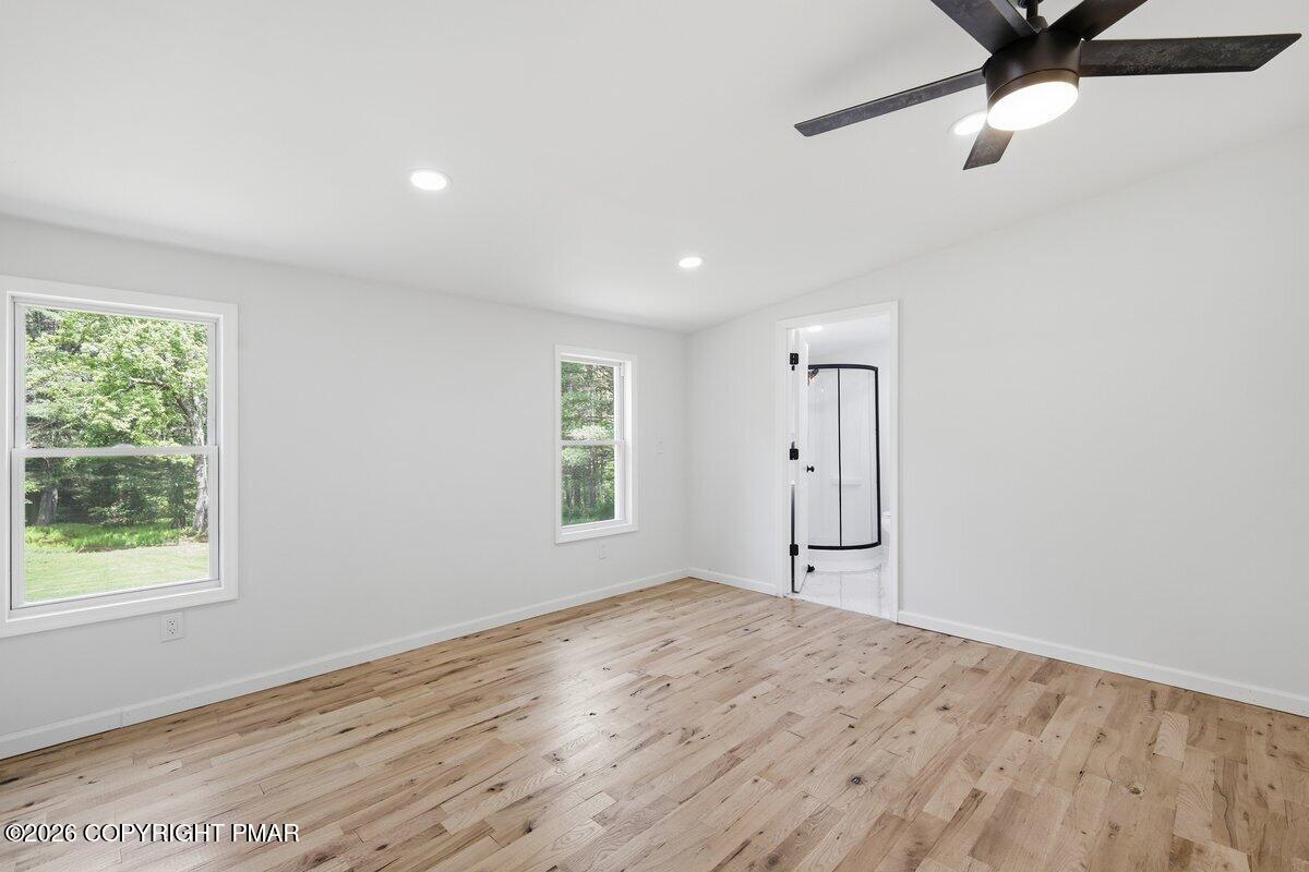 155 Blooming Grove Road Hawley, PA 18428 - Photo 26 of 41 a view of empty room with wooden floor and fan